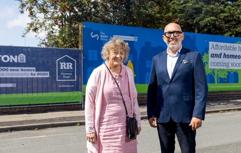 Two people stand on a residential street in front of large Sefton 2030 and Rawson Road development hoardings. The signs promote plans to build 1,000 new homes by 2030 and advertise affordable homes for rent and homeownership. The image accompanies the headline: “Sefton 2030 partnership to create skills and employment opportunities for local people.”