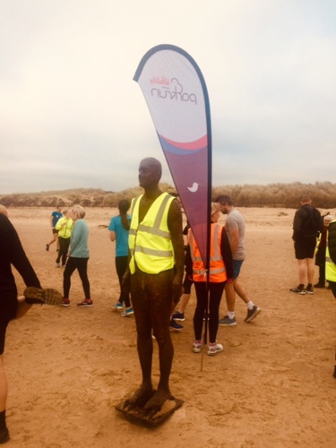 Iron man on Crosby Beach during the Crosby park Run