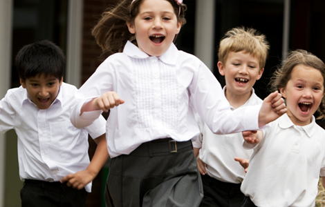Excited school pupils running