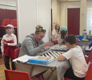 adult and child playing chess